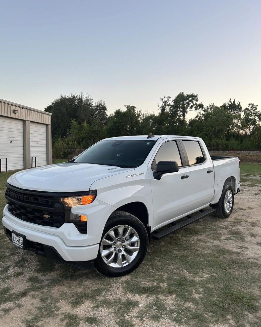 A white Chevrolet Silverado with tinted windows